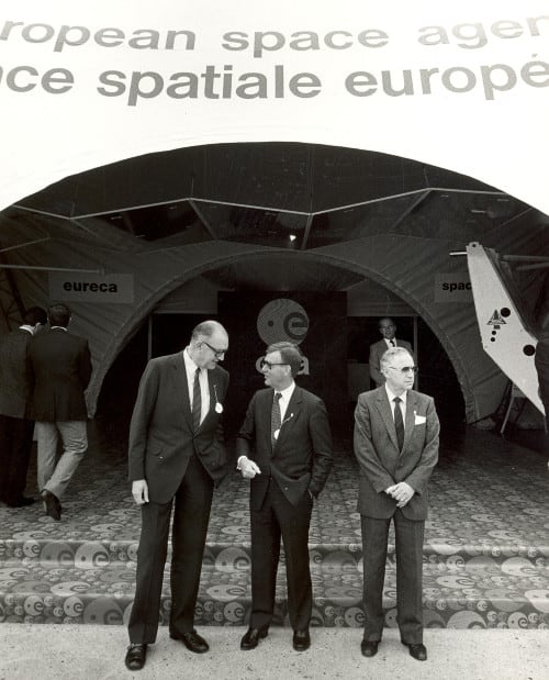 L-R: George Van Reeth, ESA Director of Administration, Reimar Lüst and Wilhelm Brado, ESA Head of Cabinet, waiting President Mitterrand at Le Bourget, 1985.